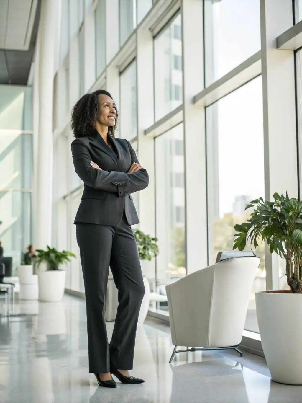 A professional business coach in a suit, smiling confidently while gesturing towards a whiteboard filled with strategic plans during a business leadership coaching session in a modern office setting.